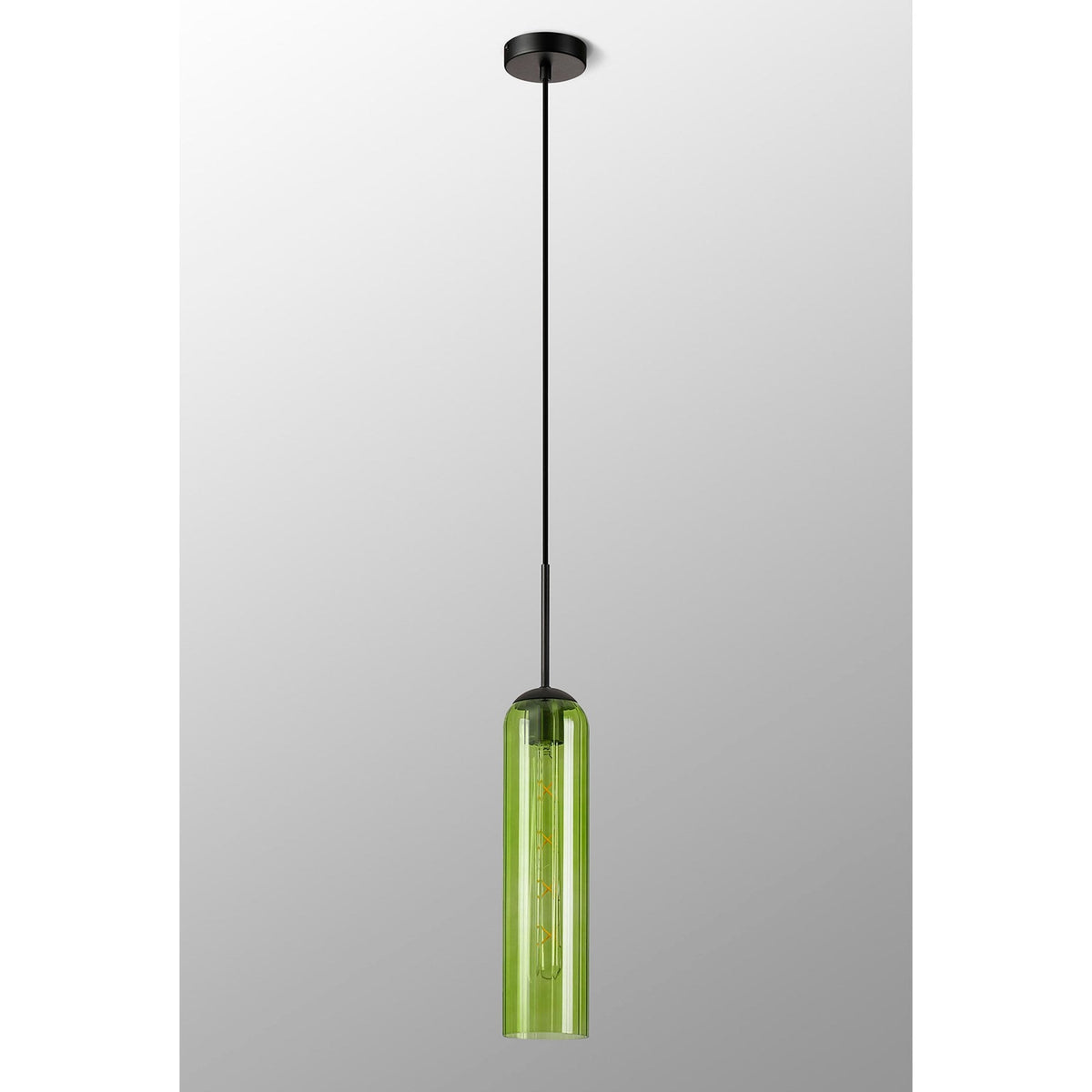A sleek, long green cylindrical pendant light hangs from a black ceiling rose.