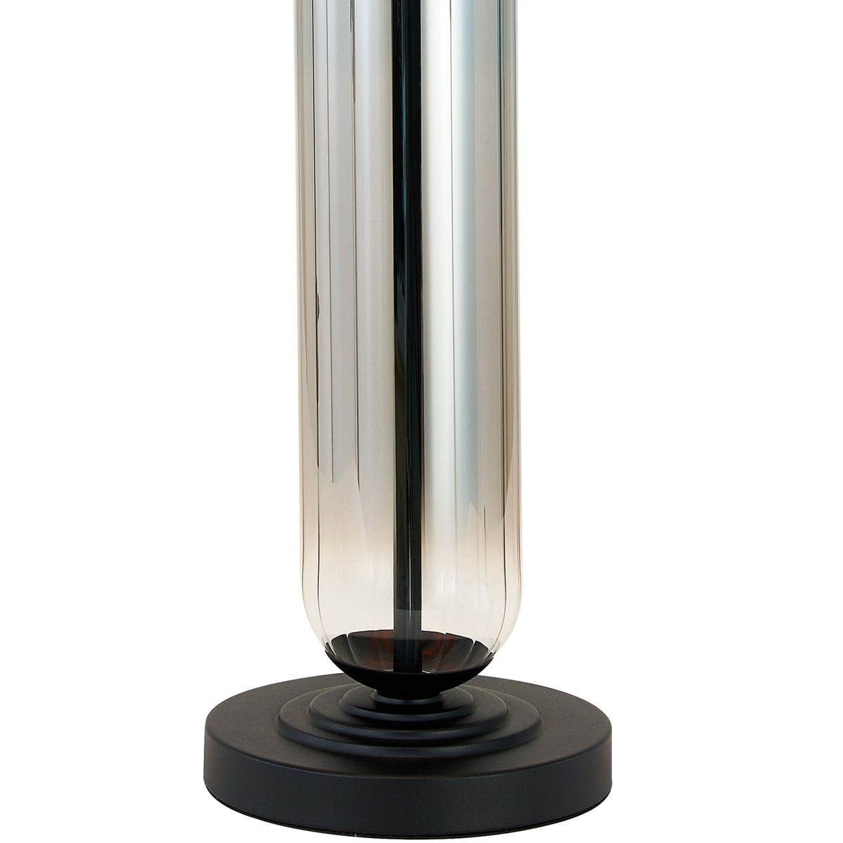 Close-up of the chrome base and dark circular stand of a modern table lamp.