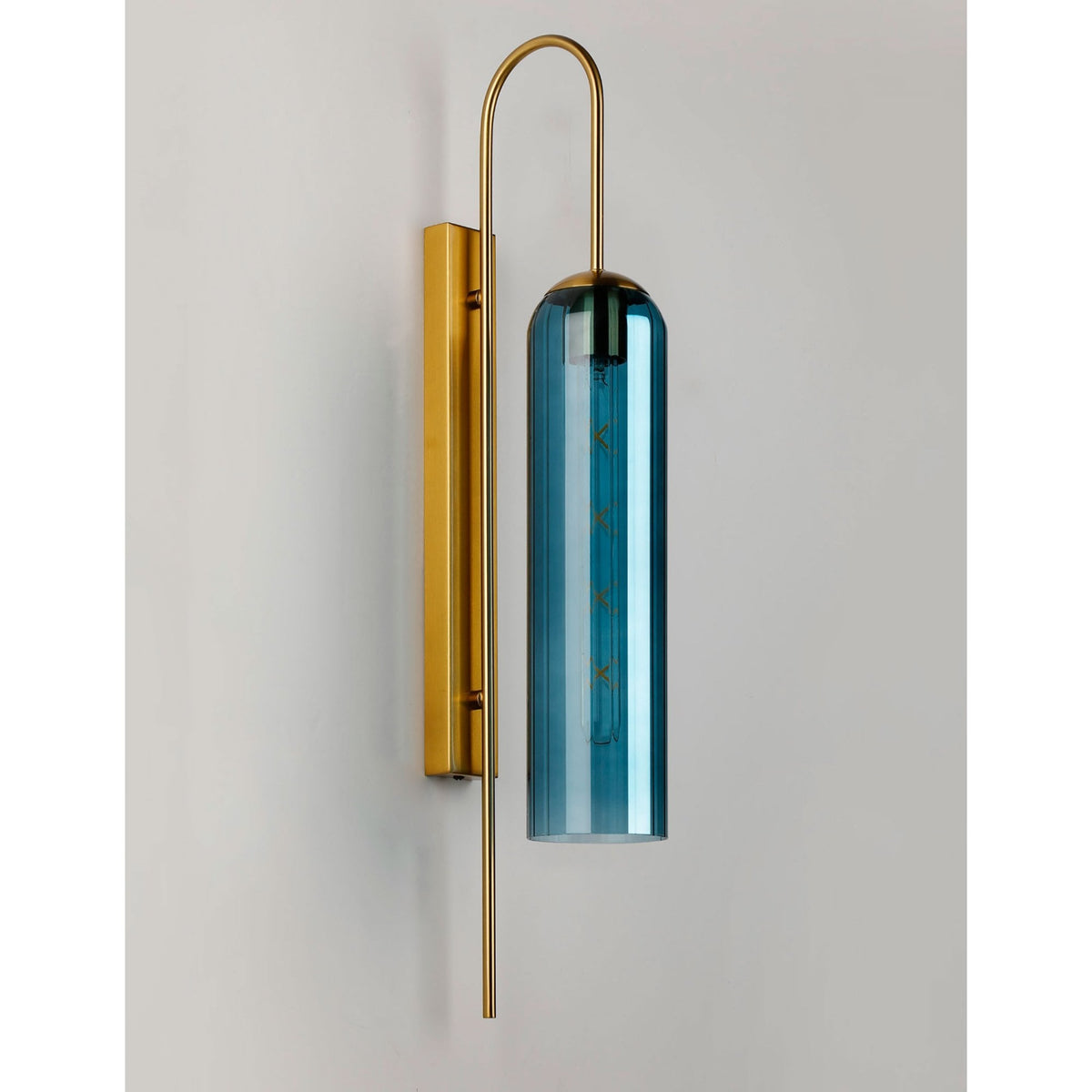 A modern brass and blue glass wall light, unilluminated against a white background.