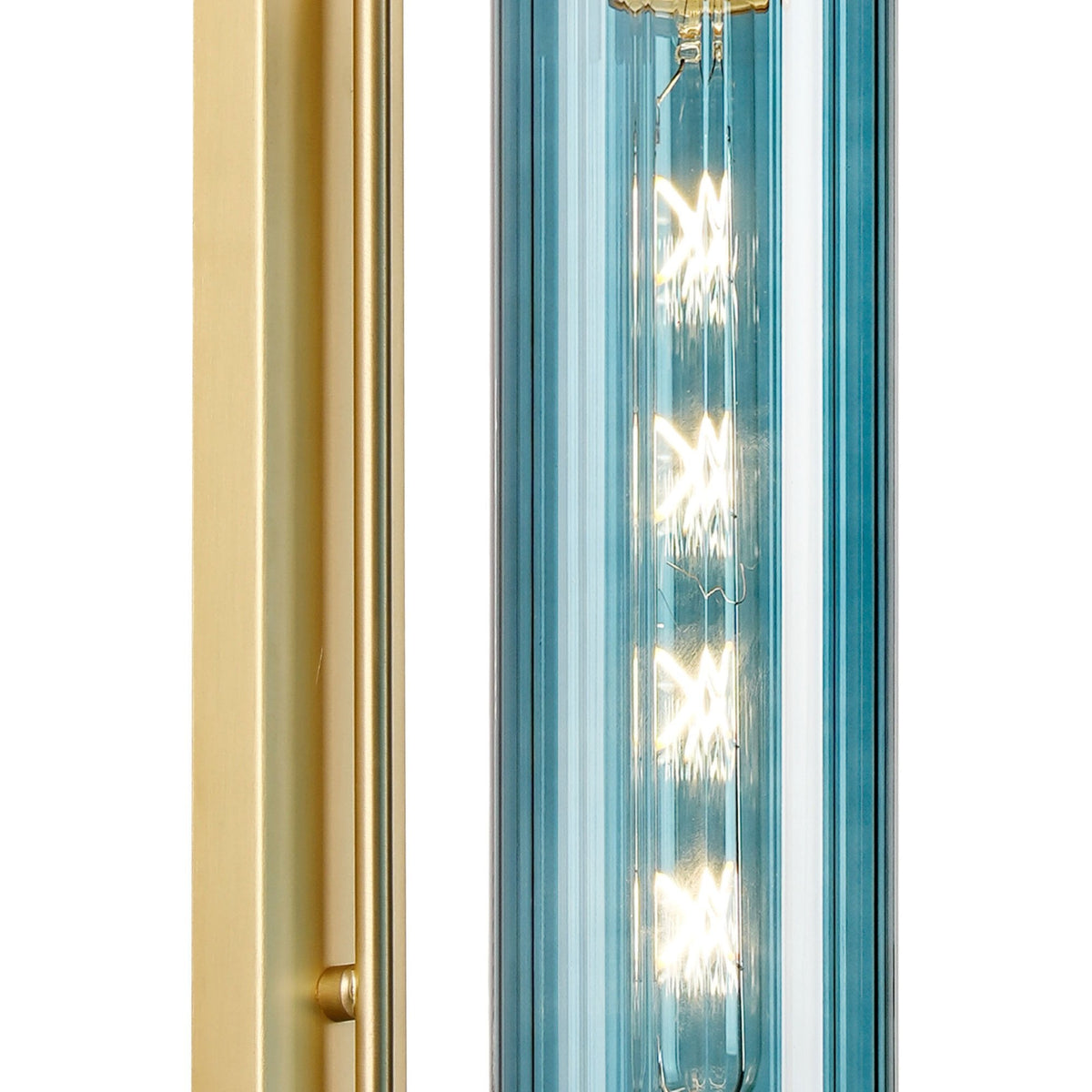 Close-up of the blue glass shade and illuminated bulb of a contemporary wall light.