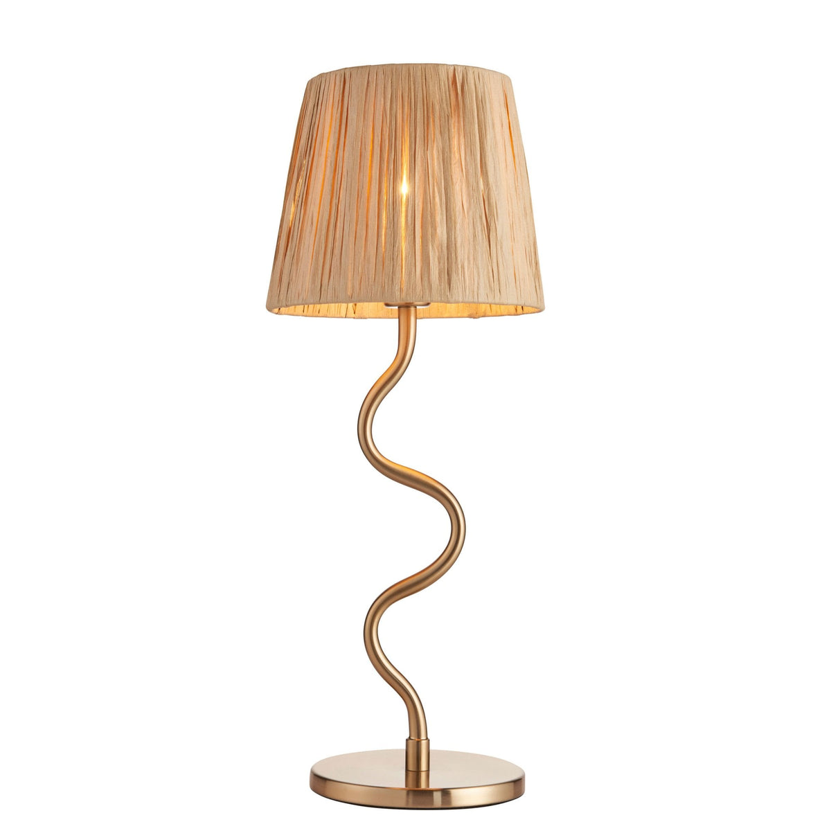 A gold table lamp with a wavy stem and a pleated beige shade, illuminated, against a white background.