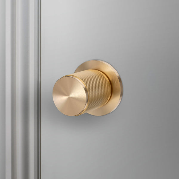 Linear Knurled Fixed Single Sided Door Knob In Brass