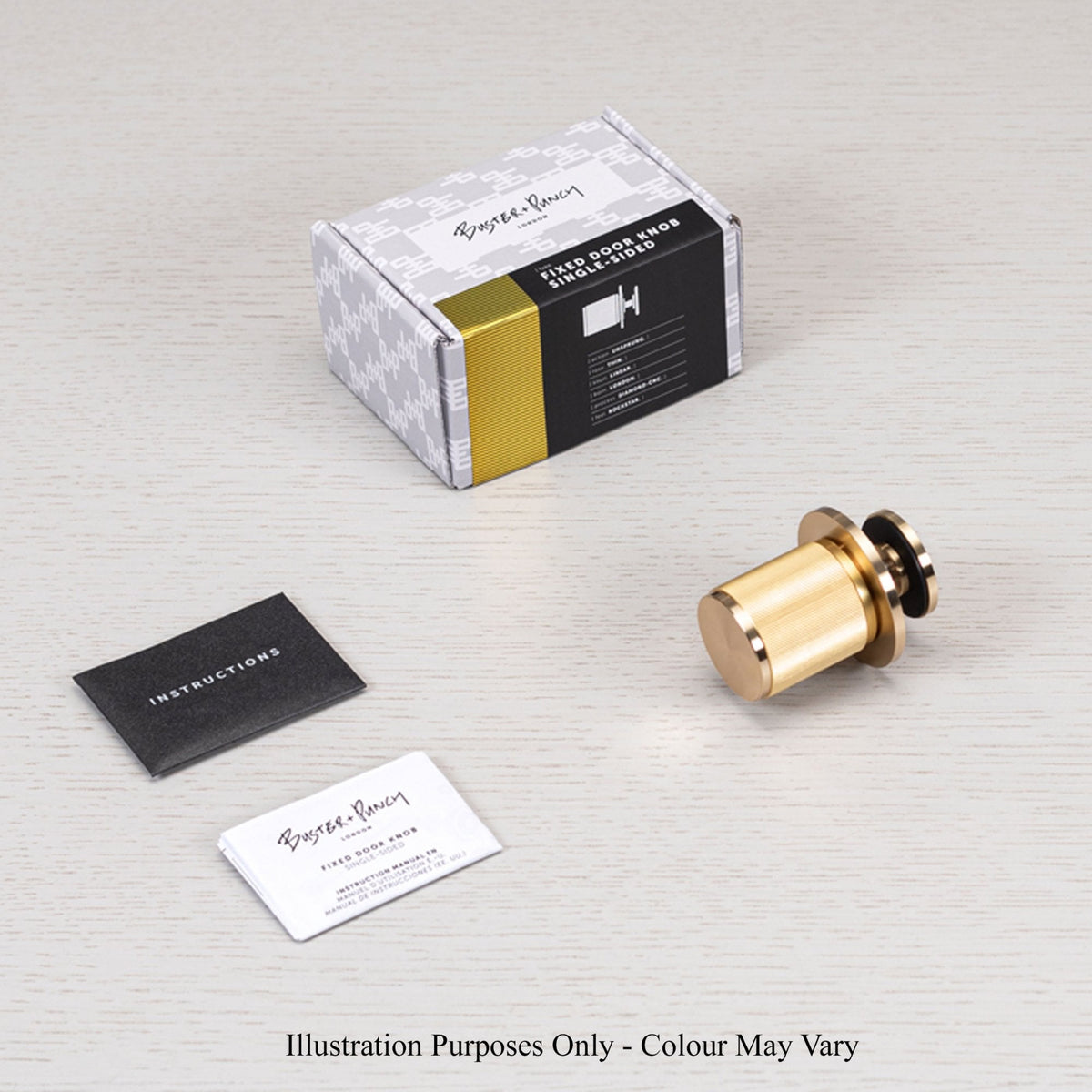 A gold door stopper, packaging, and instructions on a light background.
