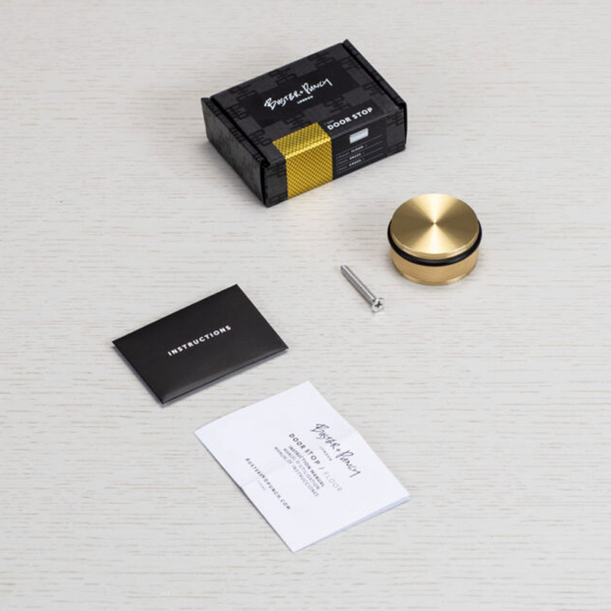 Cross Cut Knurled Door Stop In Brass