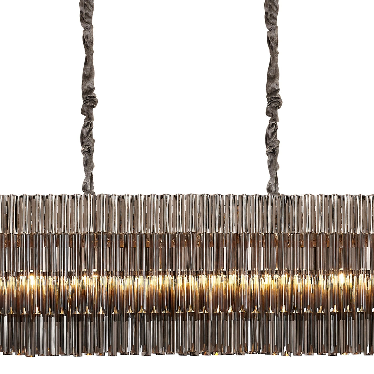 Close-up of a long, rectangular chandelier with glowing tiers of vertical glass rods.