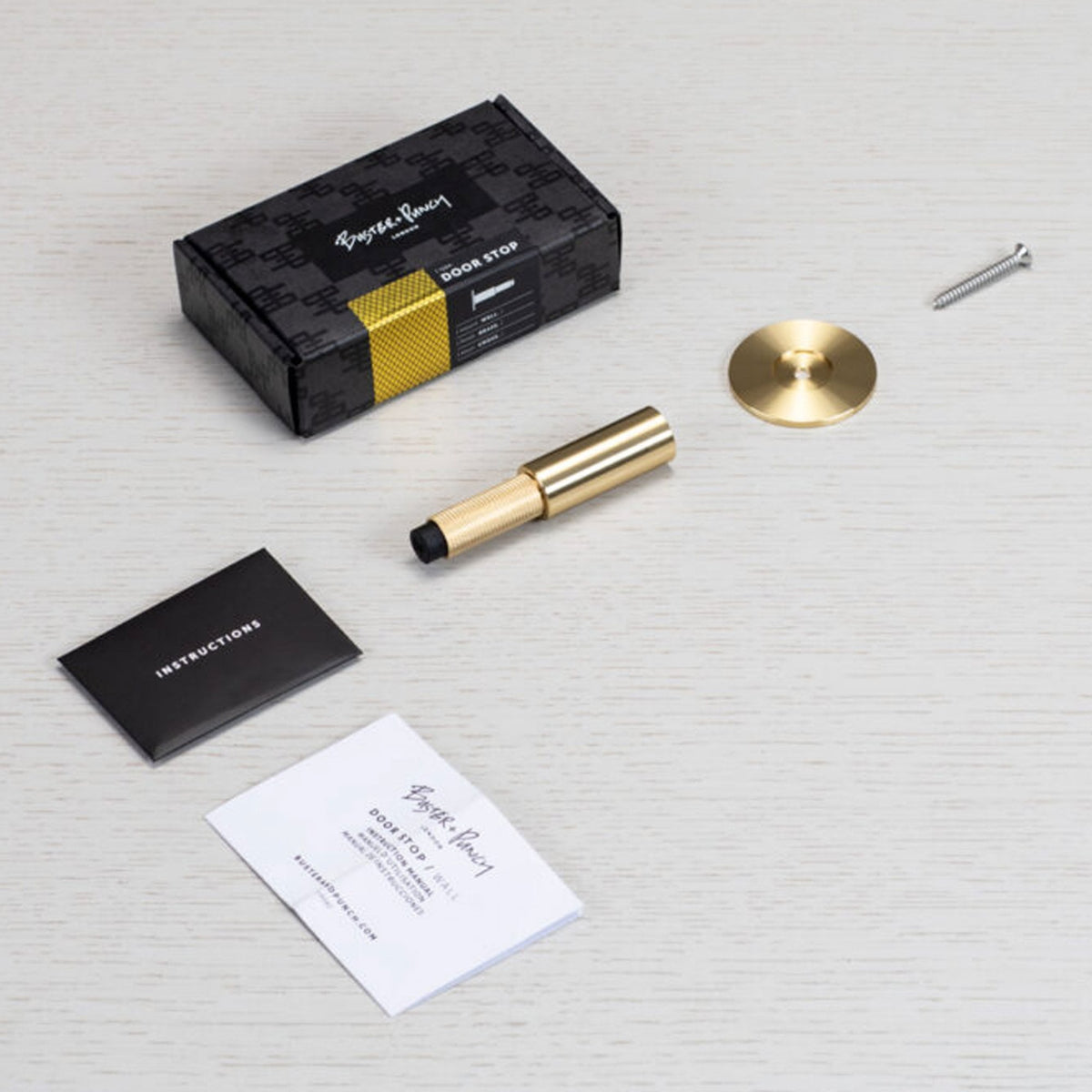 Cross Cut Knurled Wall Mounted Door Stop in Brass