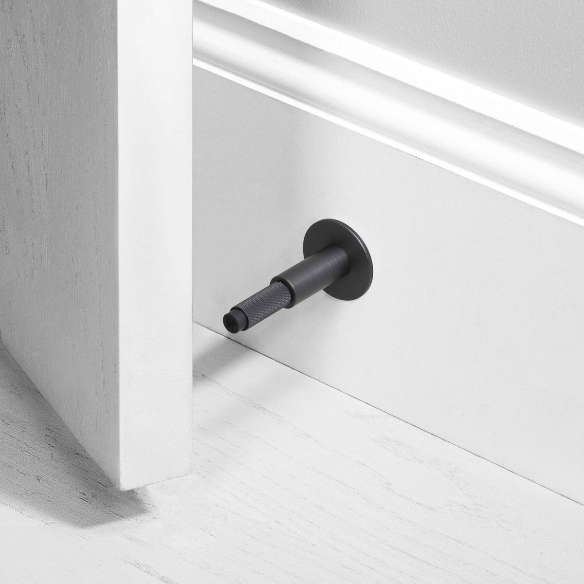 Cross Cut Knurled Wall Mounted Door Stop in Smoked Bronze