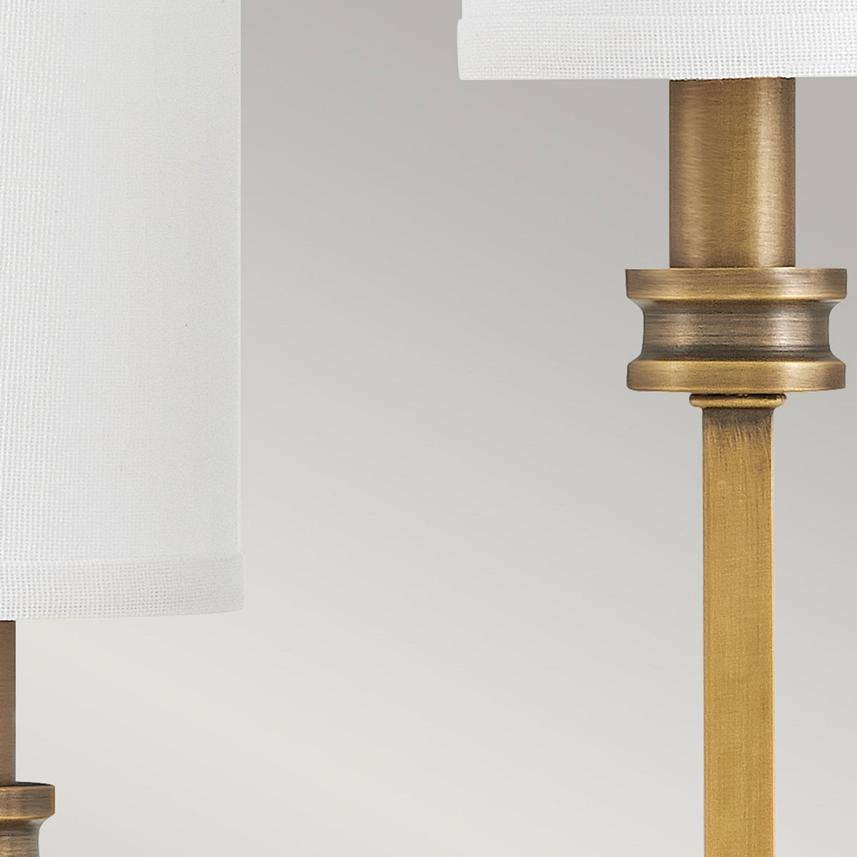Moore Triple Arm Wall Light in Heritage Brass with Ivory Linen Shades