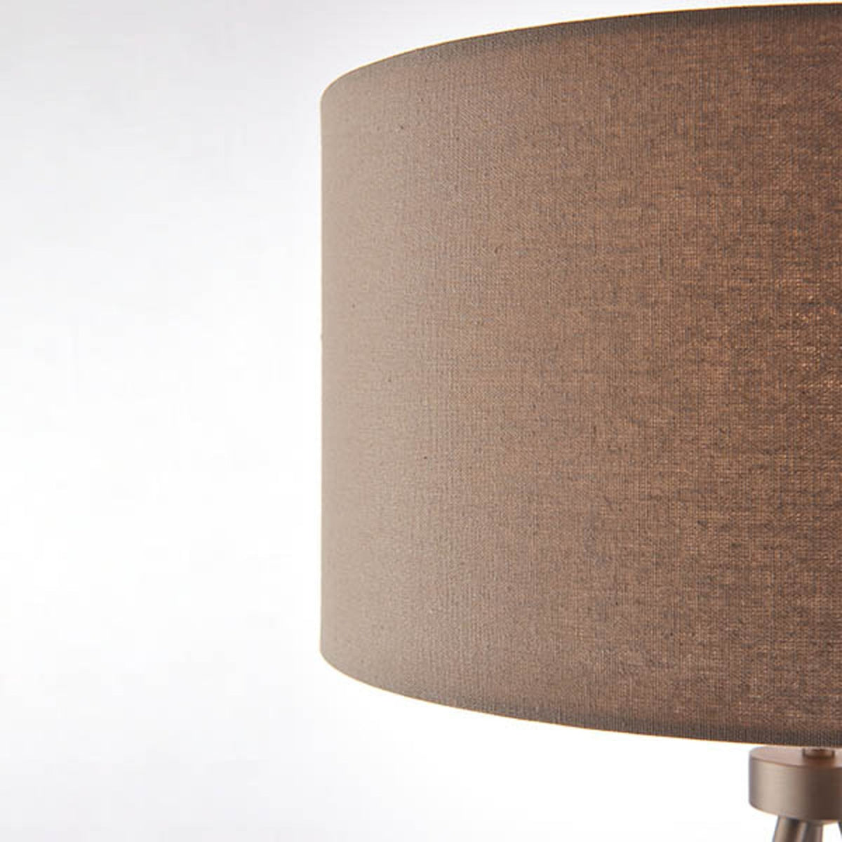 Close-up of the textured, cylindrical beige fabric lampshade.