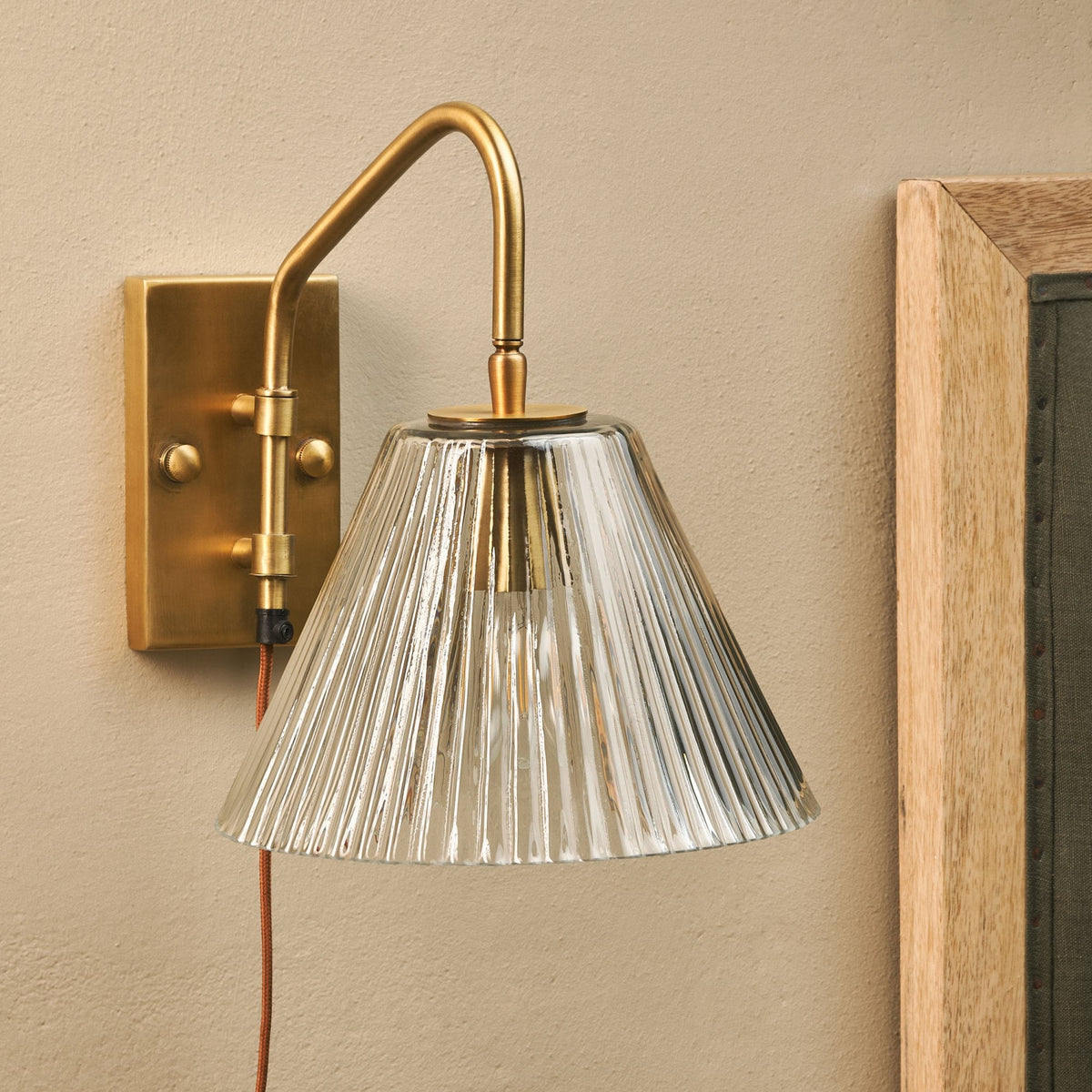 Akoli Plugged Wall Light in Antique Brass With Fluted Glass Shade