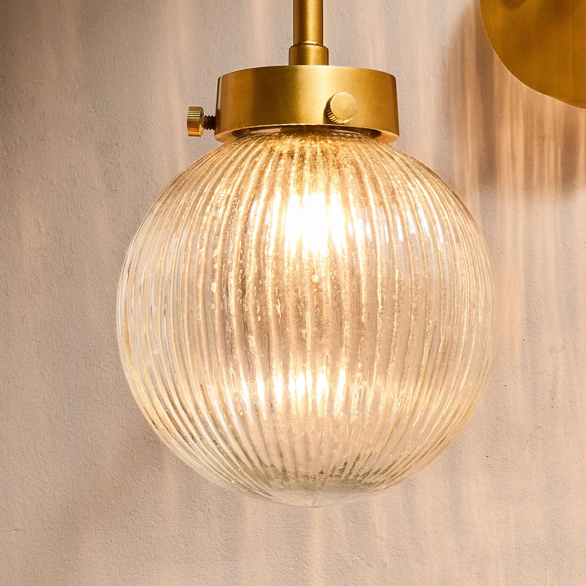 Konnie Clear Glass Bathroom Wall Light In Antique Brass
