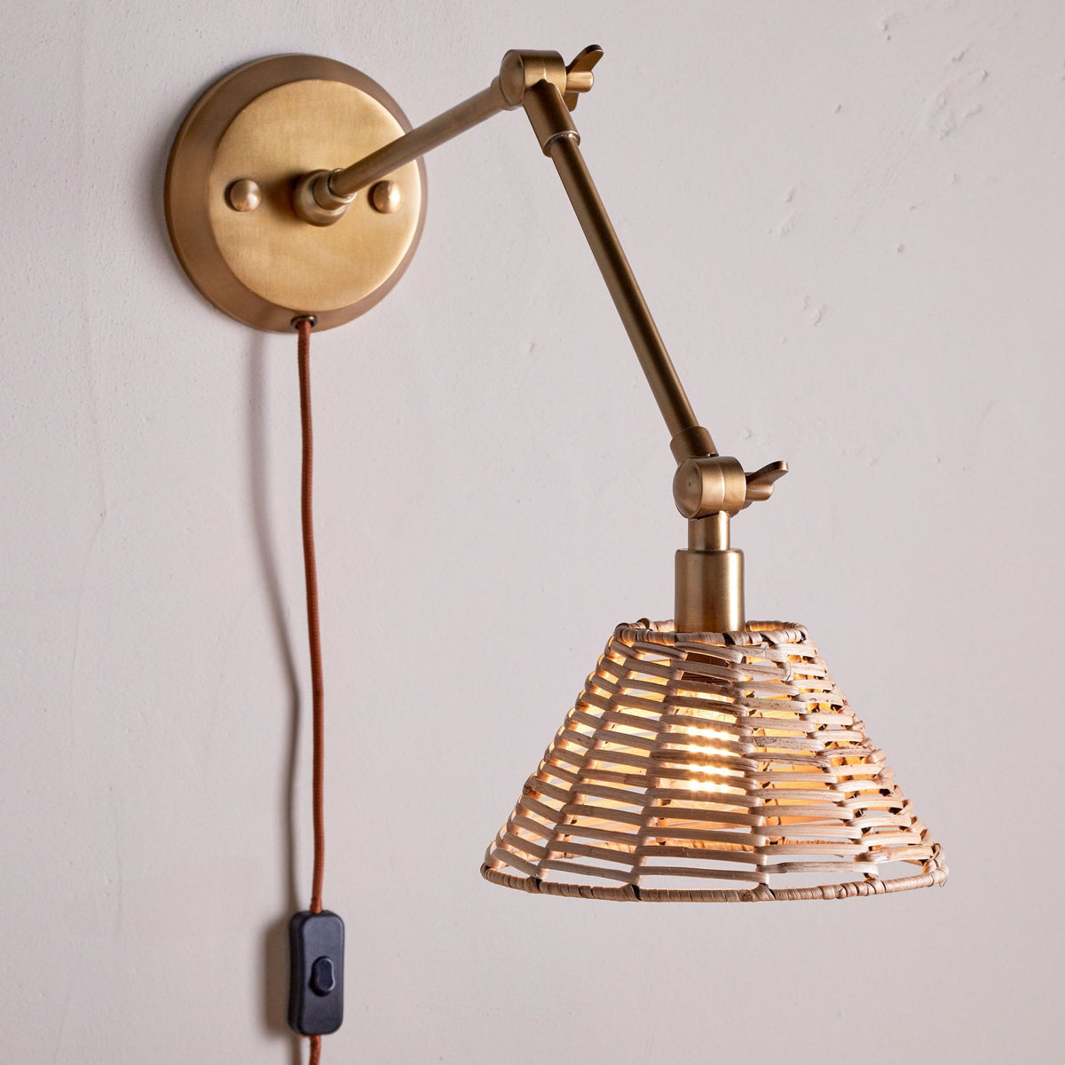 Noko Adjustable Plugged Wall Light in Antique Brass With Rattan Shade