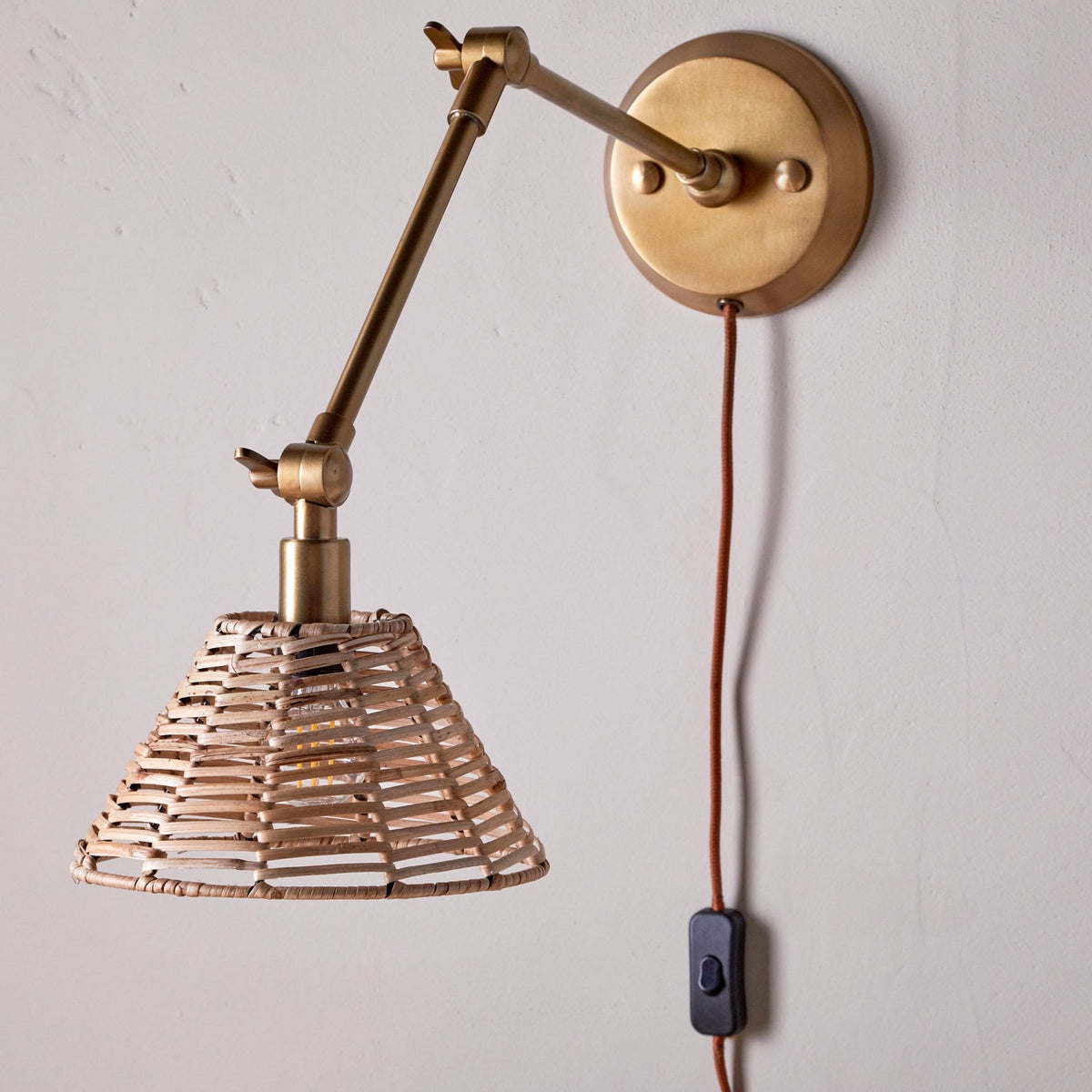 Noko Adjustable Plugged Wall Light in Antique Brass With Rattan Shade