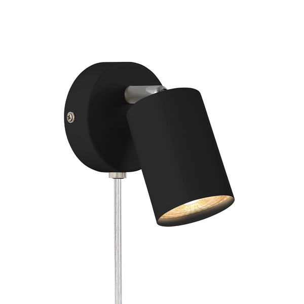 Black wall-mounted spotlight with a metallic arm, casting a warm glow.