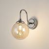Loughton IP44 Curved Arm Wall Light in Polished Nickel with Smooth Round Glass Amber Diffuser