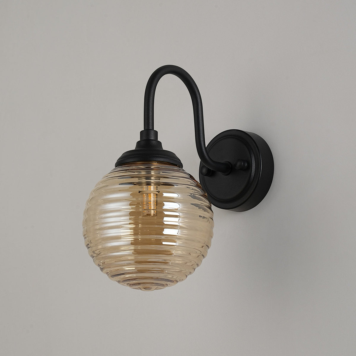 Loughton IP44 Curved Arm Wall Light in Satin Black with Ribbed Round Glass Amber Diffuser