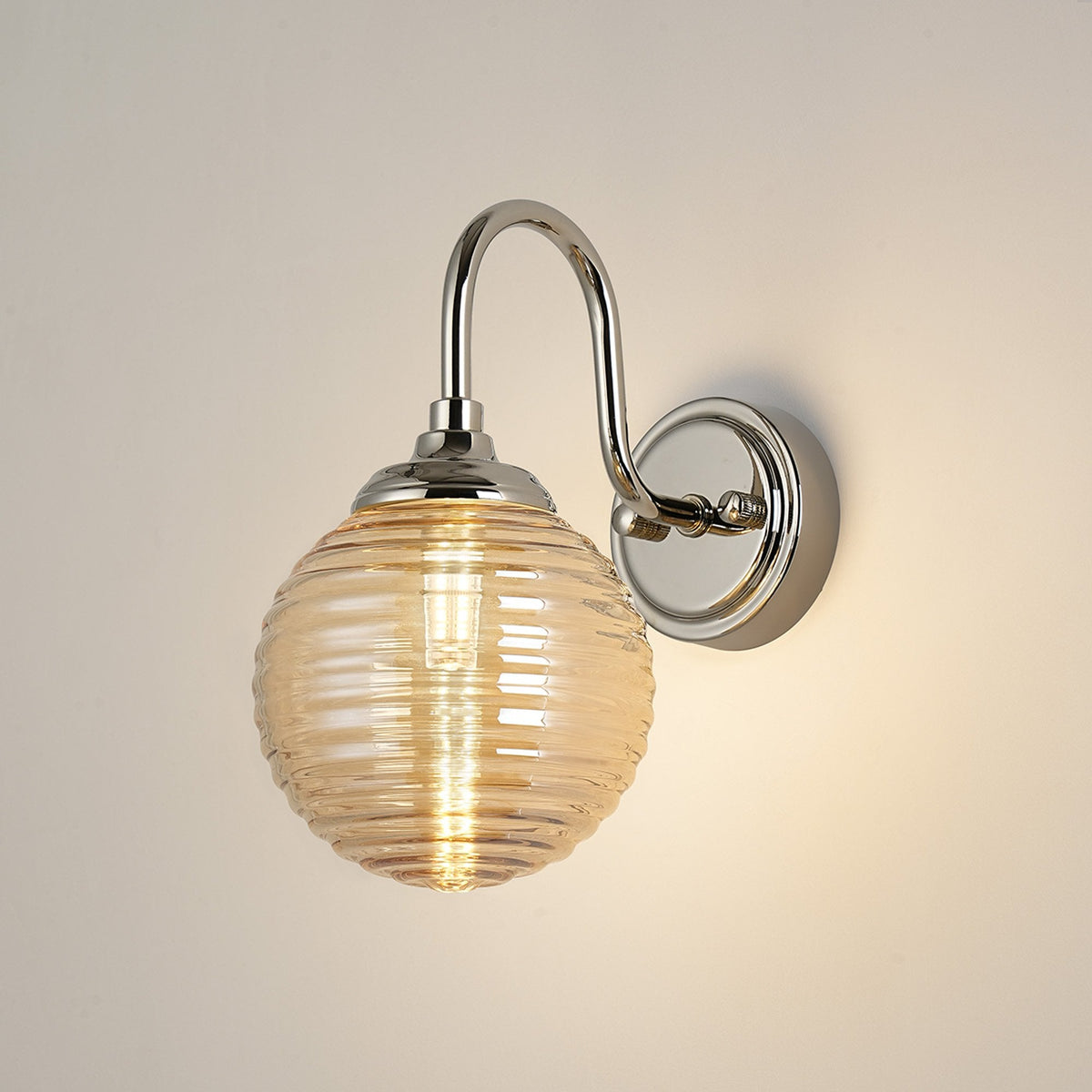 Loughton IP44 Curved Arm Wall Light in Polished Nickel with Ribbed Round Glass Amber Diffuser