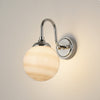 Loughton IP44 Curved Arm Wall Light in Polished Nickel with Round Glass Brown & White Marble Effect Diffuser
