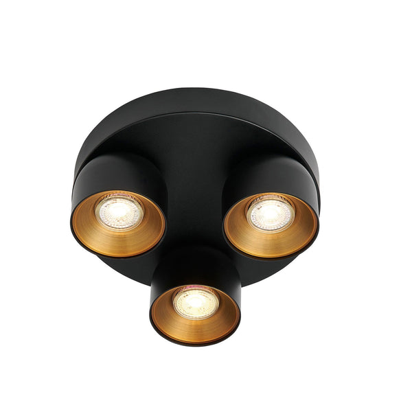 A black three-spot ceiling light with golden interiors, providing bright illumination.