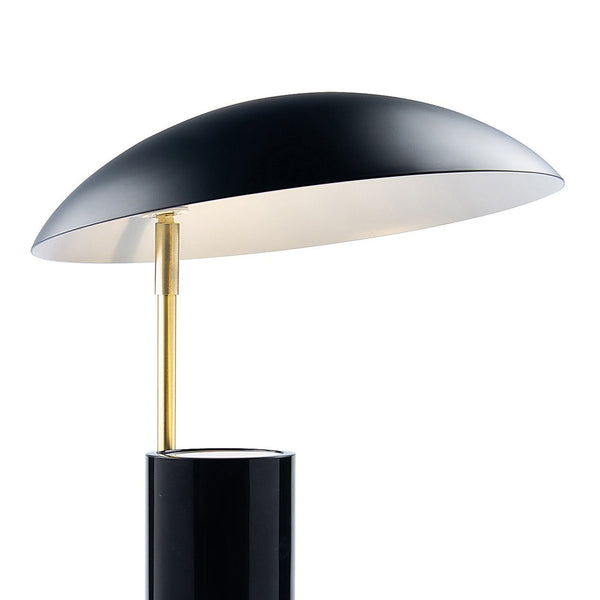 Close-up of the table lamp, highlighting its brass stem and mushroom-shaped shade.