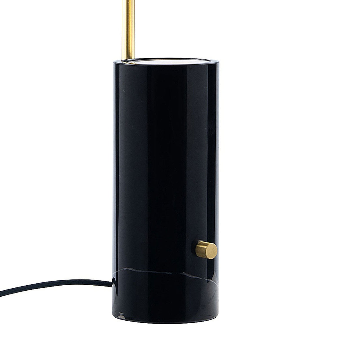 Detail of the black marble base of the table lamp with a brass dimmer switch.