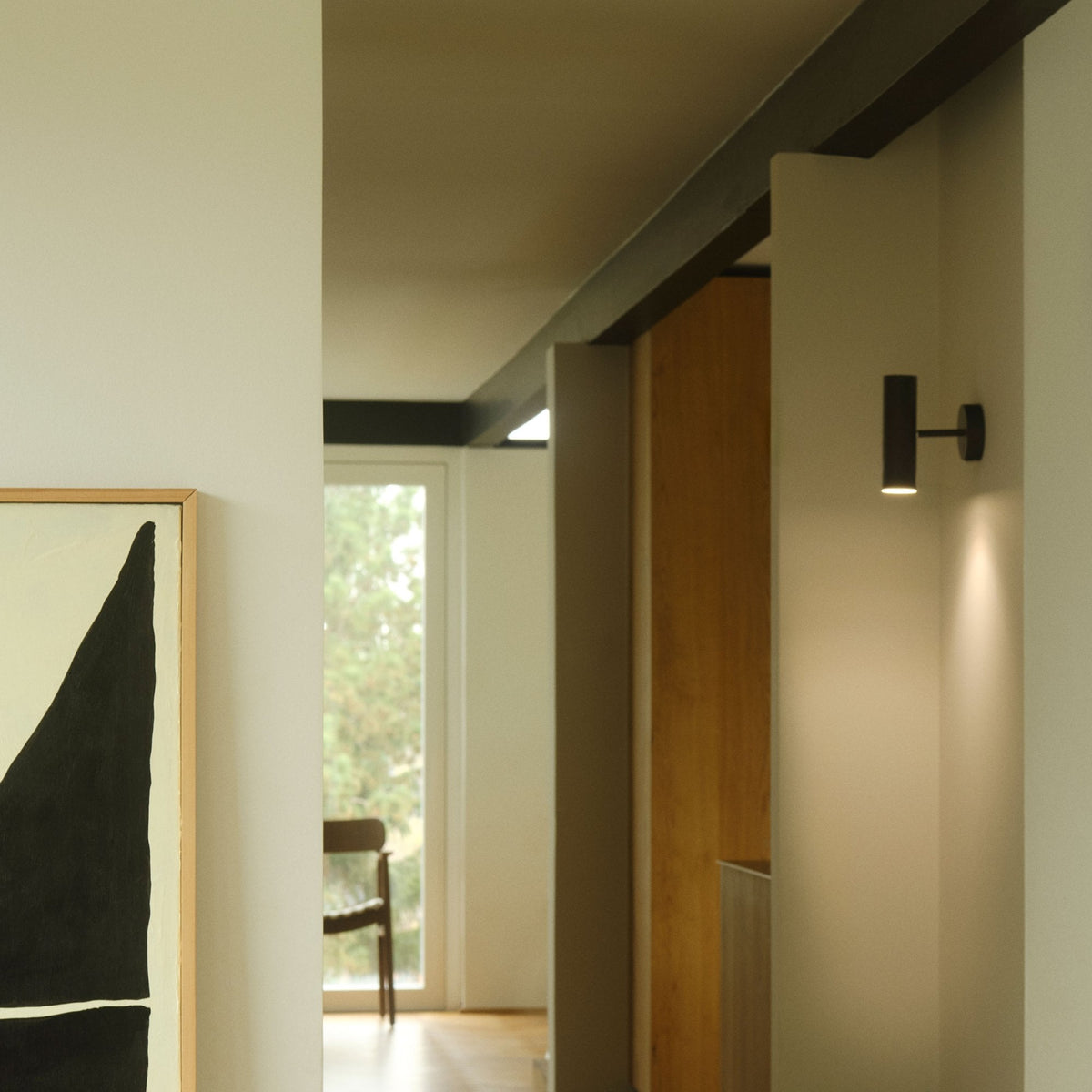 DFTP By Nordlux Mib Plugged Adjustable Wall Spotlight in Black illuminates a modern hallway