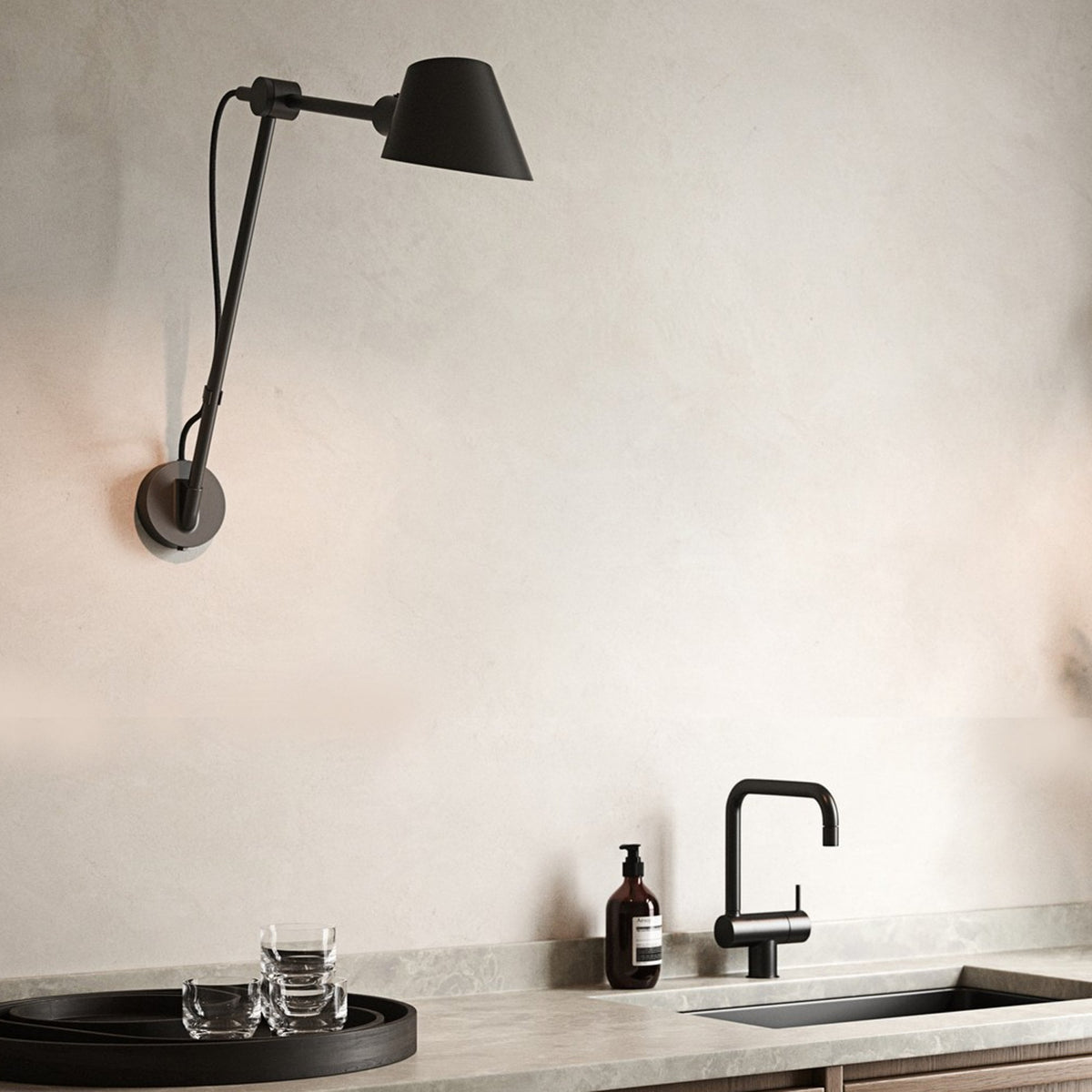 DFTP By Nordlux Stay Swing Arm Plugged Wall Light in Matt Black above a kitchen sink
