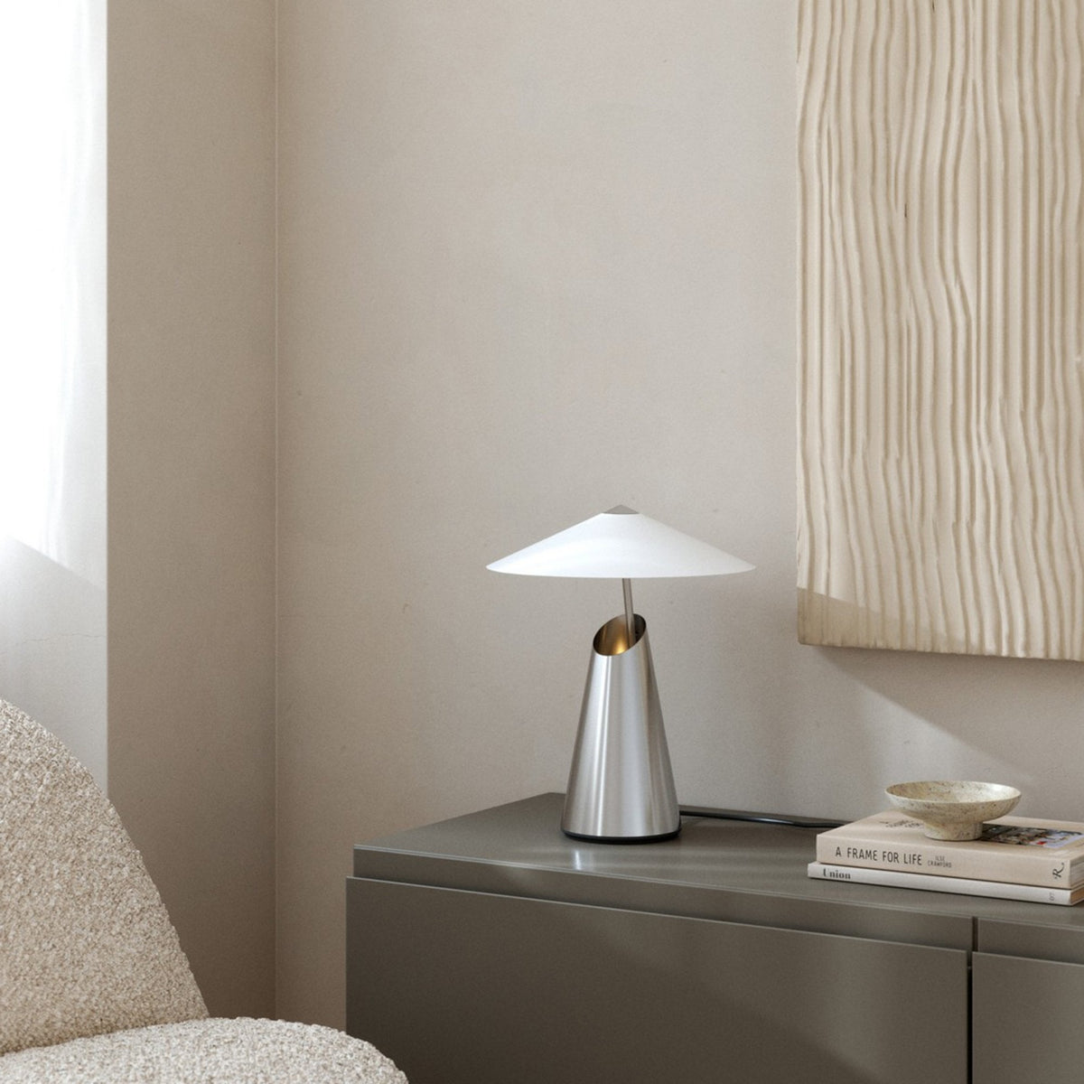 DFTP By Nordlux Taido Geometric Table Lamp in Chrome on a grey cabinet