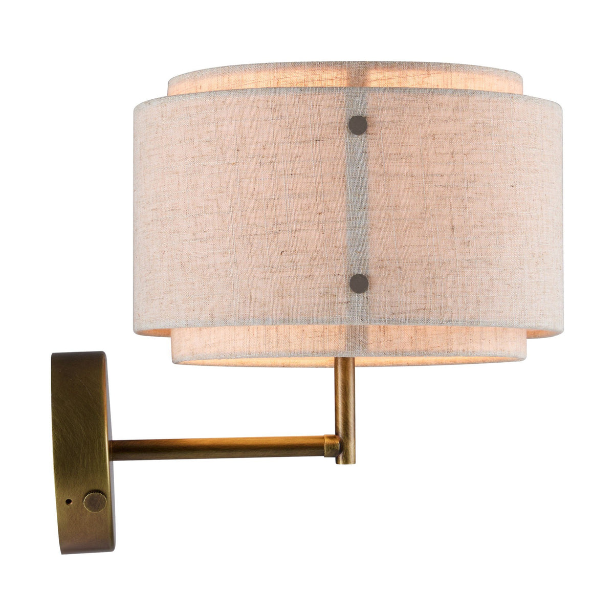 A close-up of a wall light with a textured fabric shade and a brass finish.