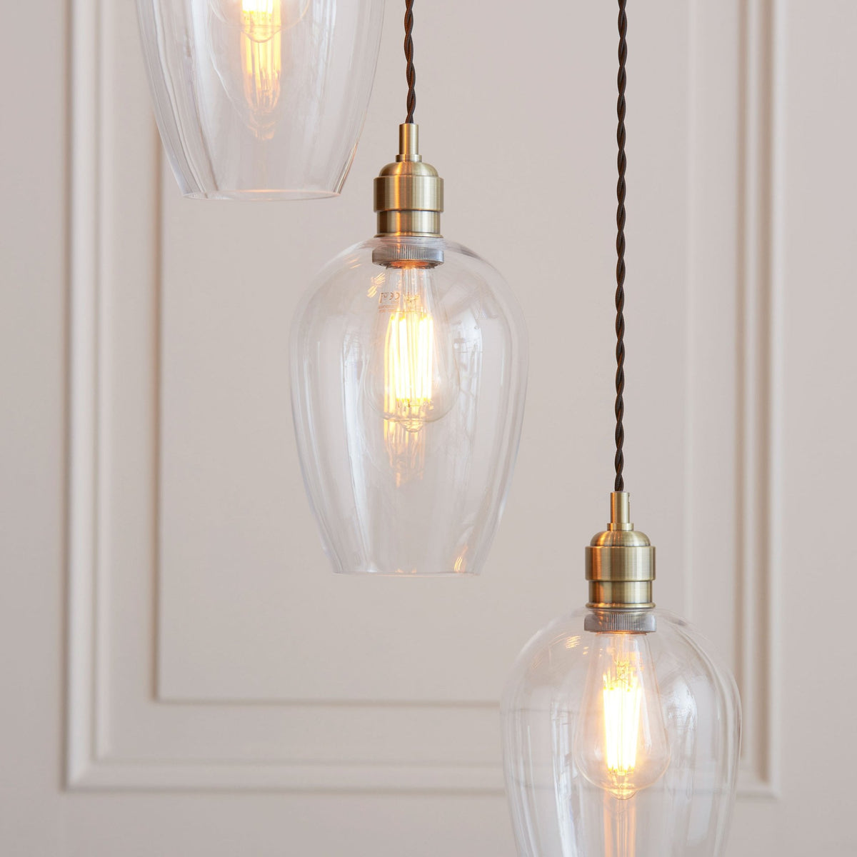 Hoburne 7 Light Cascade Pendant in Antique Brass with Clear Glass