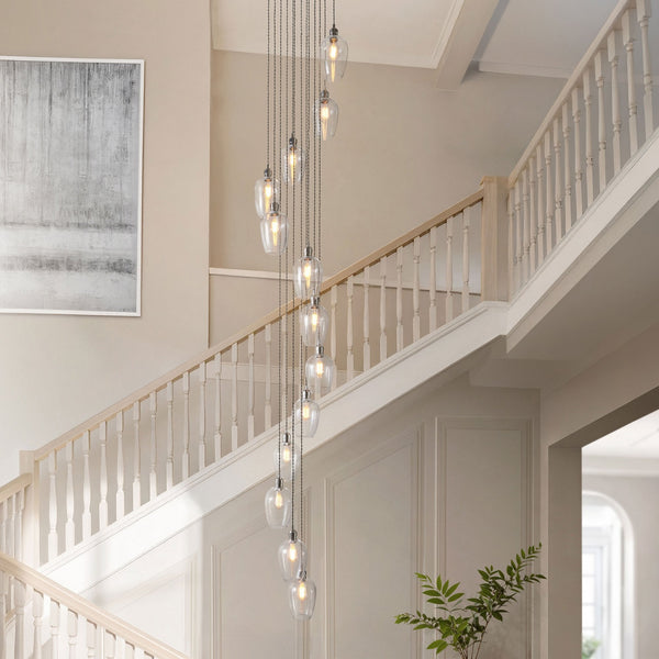 A staircase with a long, multi-bulb pendant light fixture cascading downwards.