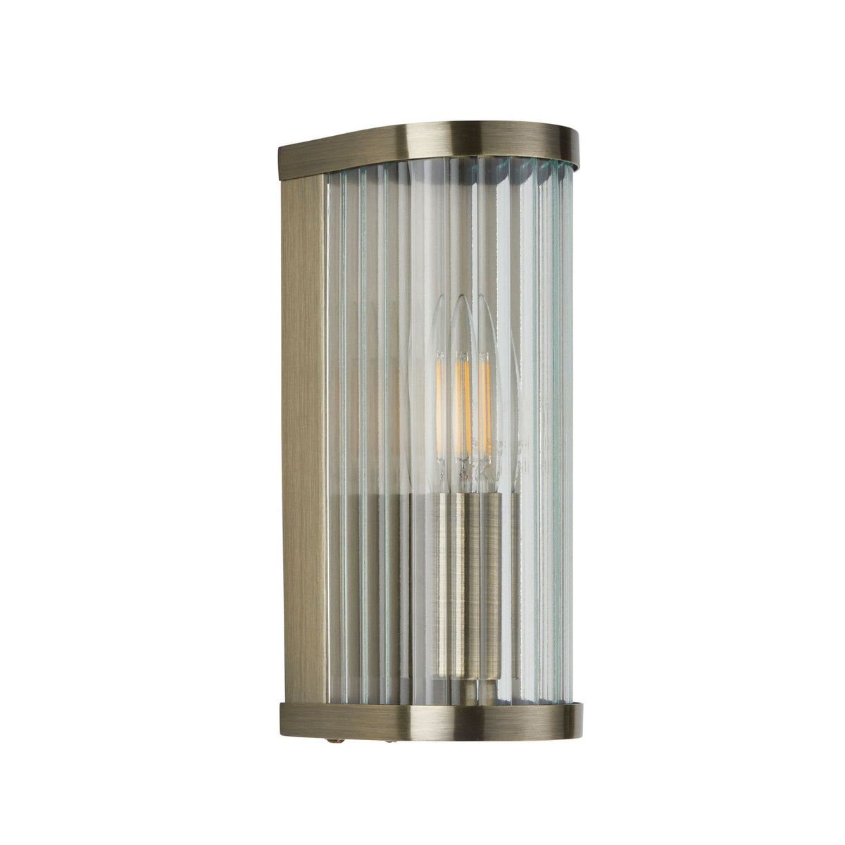 A gold-plated, wall-mounted light with a clear fluted glass shade on a white background, unlit.