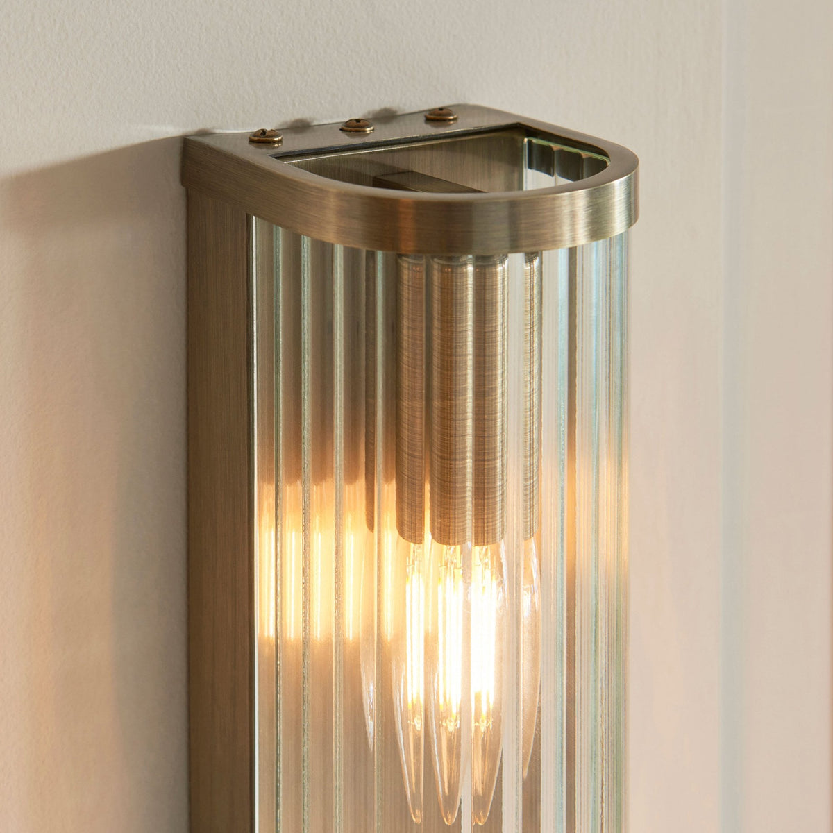 Ridgeton Twin Lamp Wall Light in Antique Brass & Clear Ribbed Glass