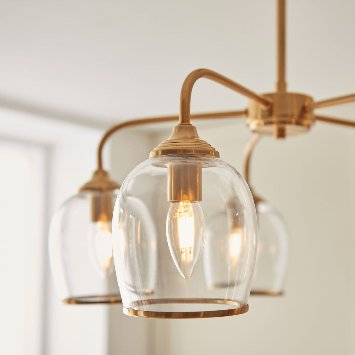 Ashcroft Five Light Pendant in Brushed Aged Brass & Clear Glass Shades with Metal Trim Edge
