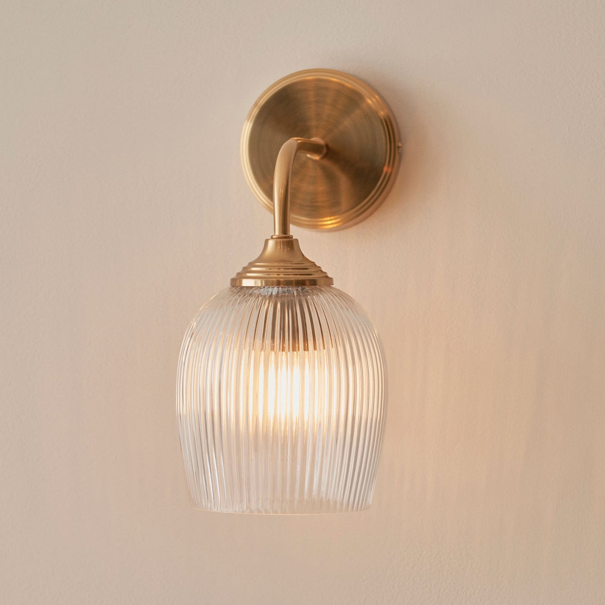 Ashcroft Wall Light in Brushed Aged Brass & Clear Ribbed Glass Shade