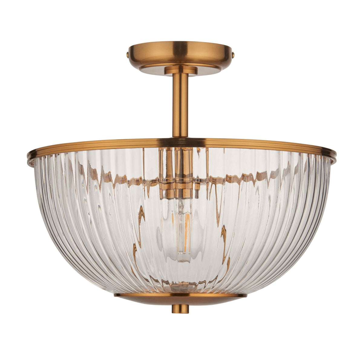 A semi-flush mount ceiling light with a ribbed glass bowl shade and antique brass finish.