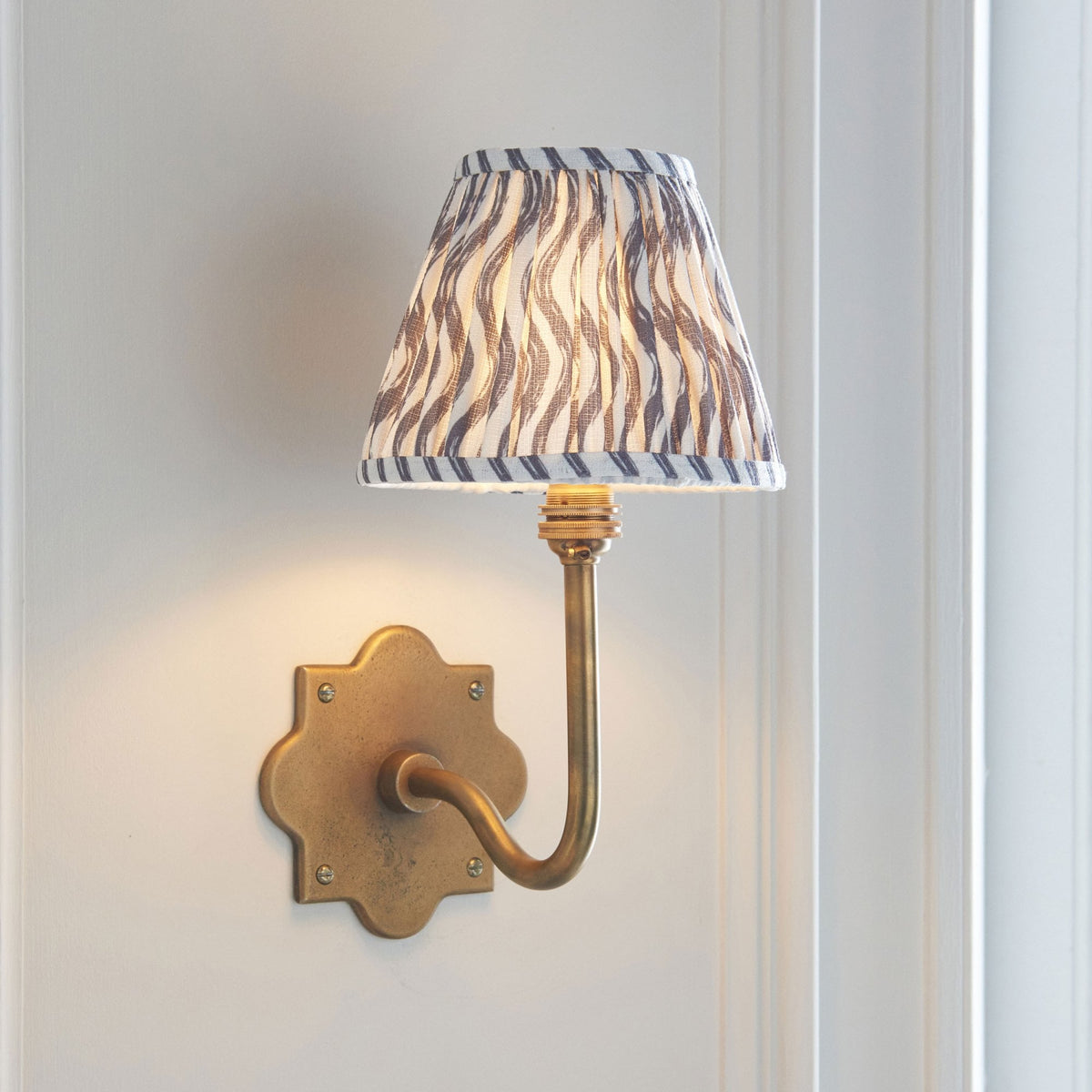 Anvil Swan Wall Light in Brass Patina with 16cm Ripple Pearl Grey Faux Linen Fabric Shade