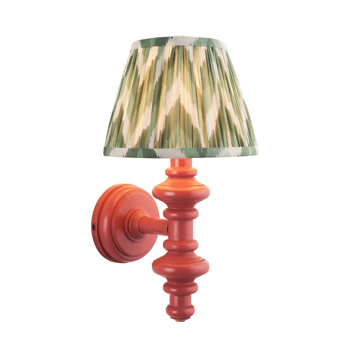 Red wall sconce with a pleated green and white patterned lampshade