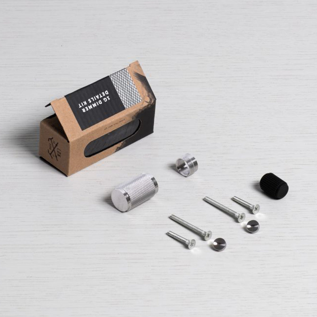 1G Dimmer Details Kit with various metal components and a black knob on a white surface.