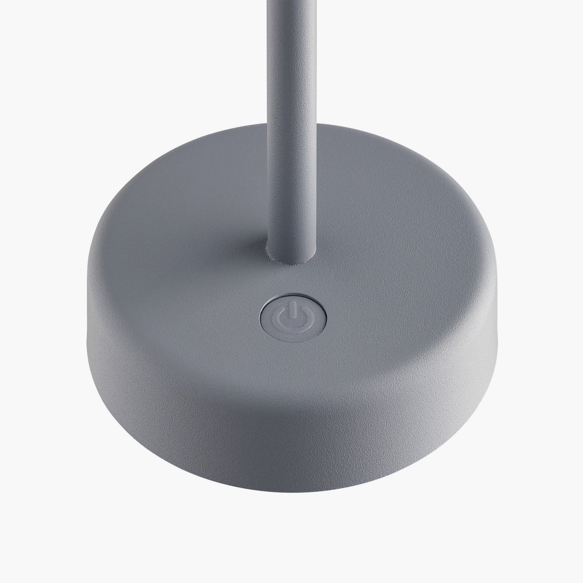 Close up of the light grey lamp base with a power button on top