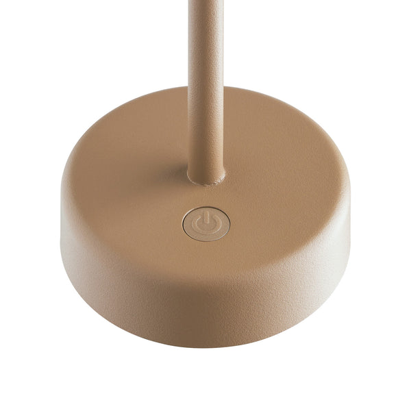 Close up of the base of a beige lamp with a power button