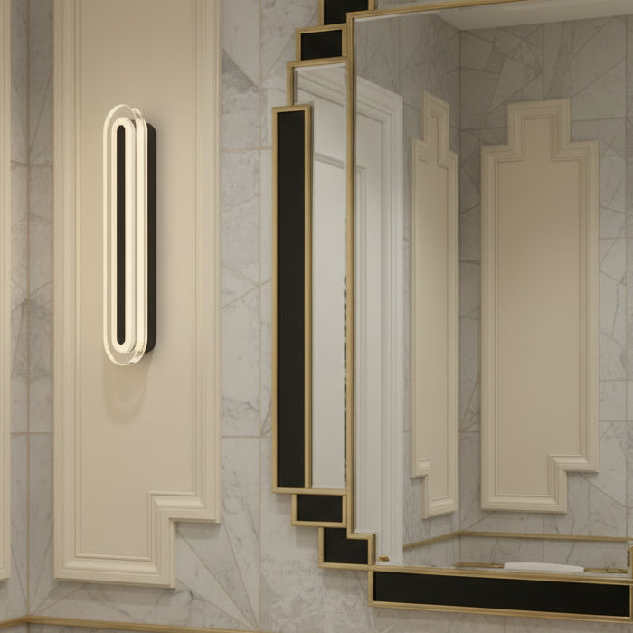 Art Deco style mirror with black and gold frame next to a vertical oval wall light