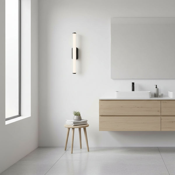 Modern bathroom with a light wood vanity, white rectangular sink, and a vertical black and white light fixture