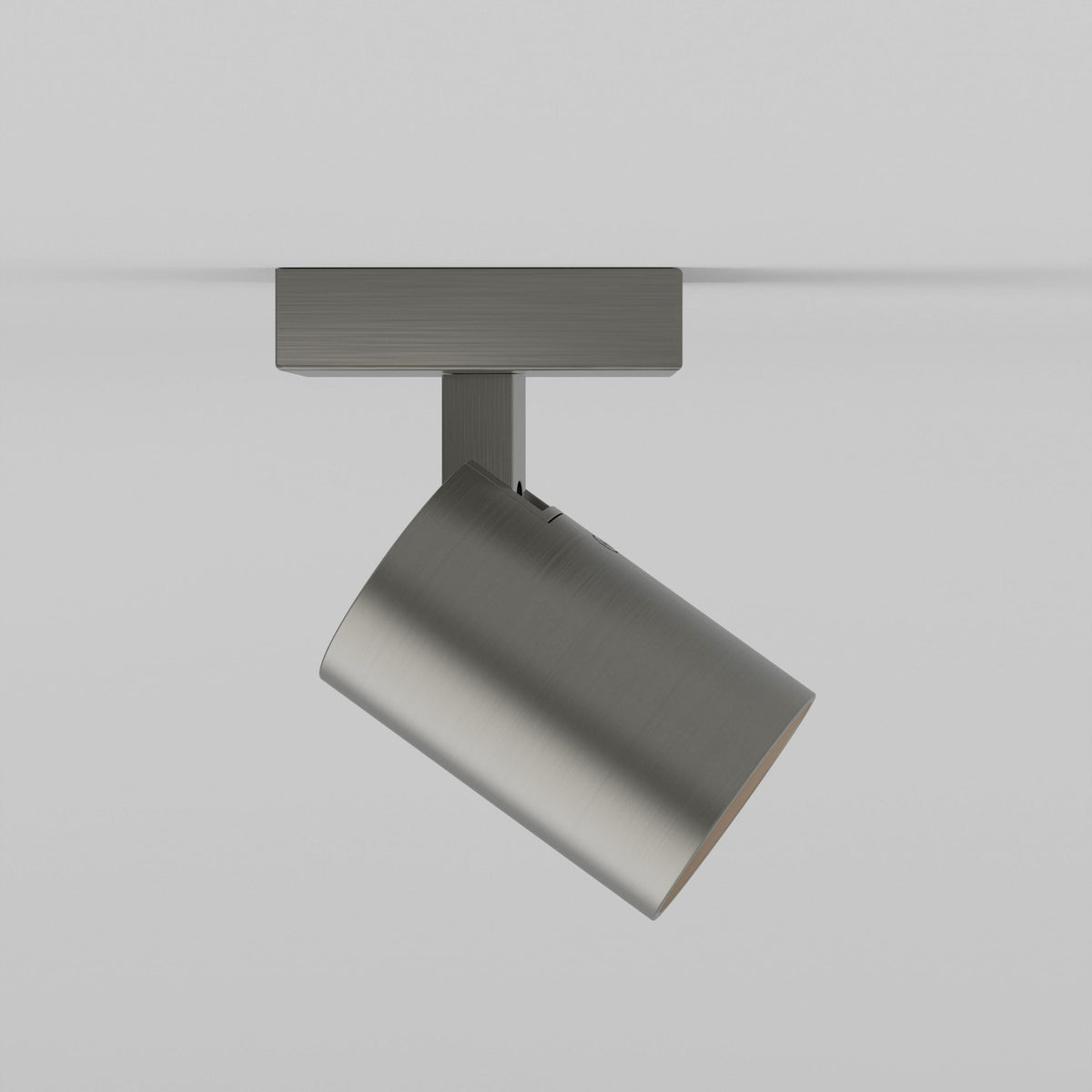 Brushed steel ceiling spotlight with a cylindrical head angled downwards