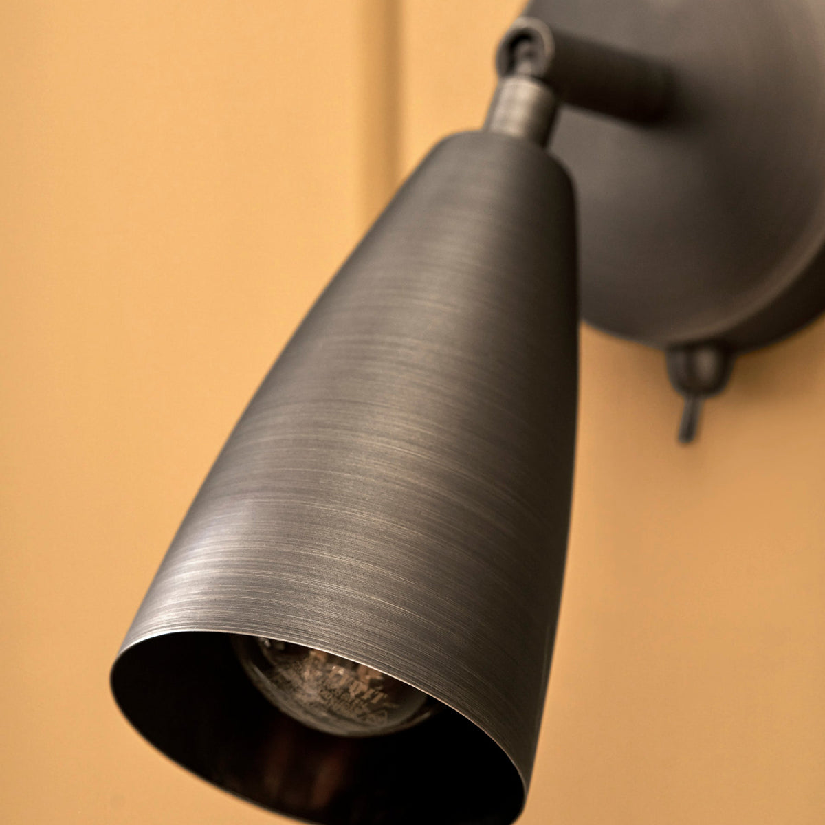 Brushed dark metal cone shaped wall spotlight