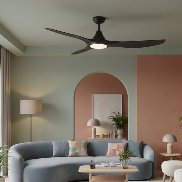 Black ceiling fan with light in a living room with a blue sofa and arched doorway