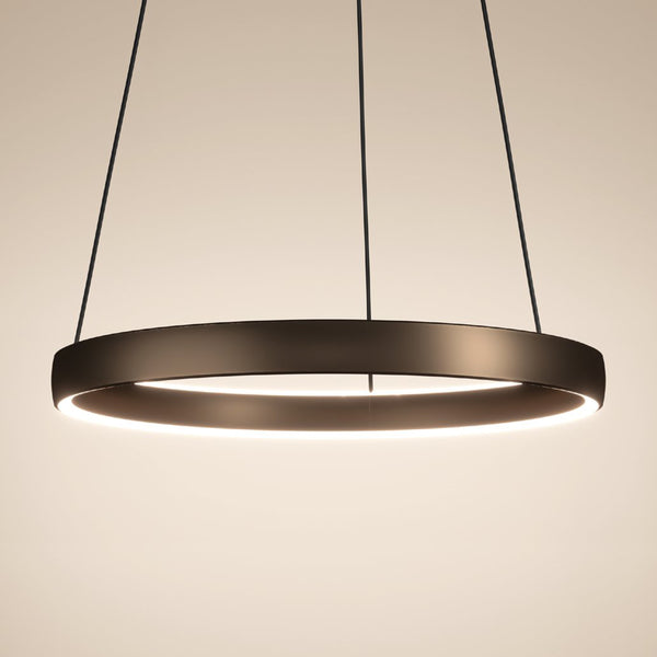 Modern circular LED pendant light in a dark finish, suspended by thin black wires against a light background.