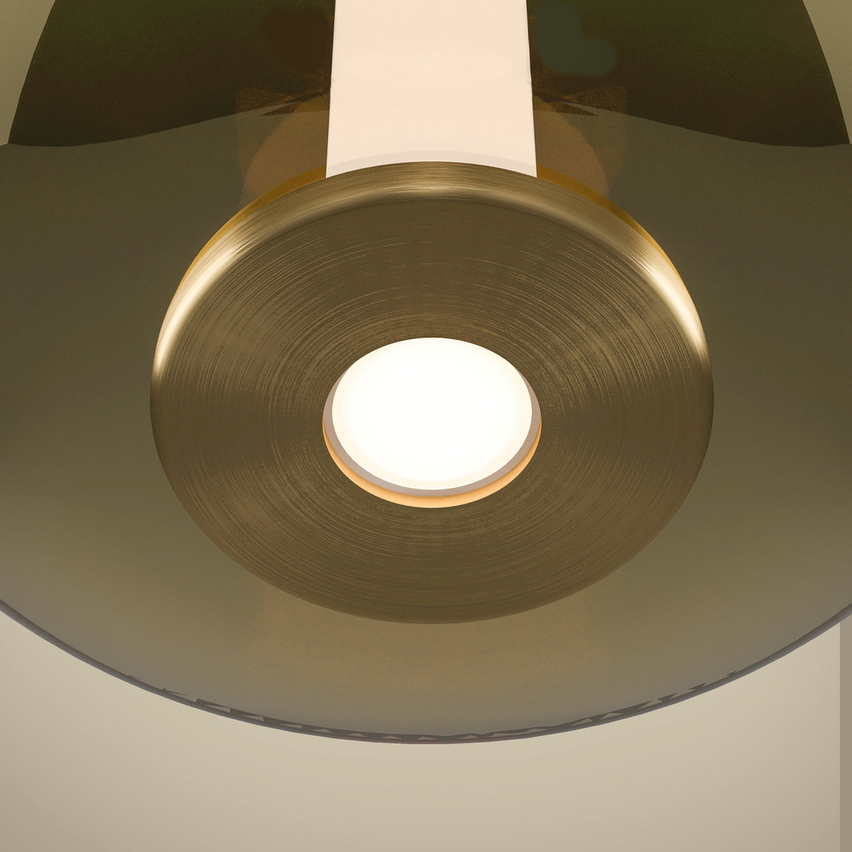 Close-up of a modern brass light fixture with a circular illuminated center.