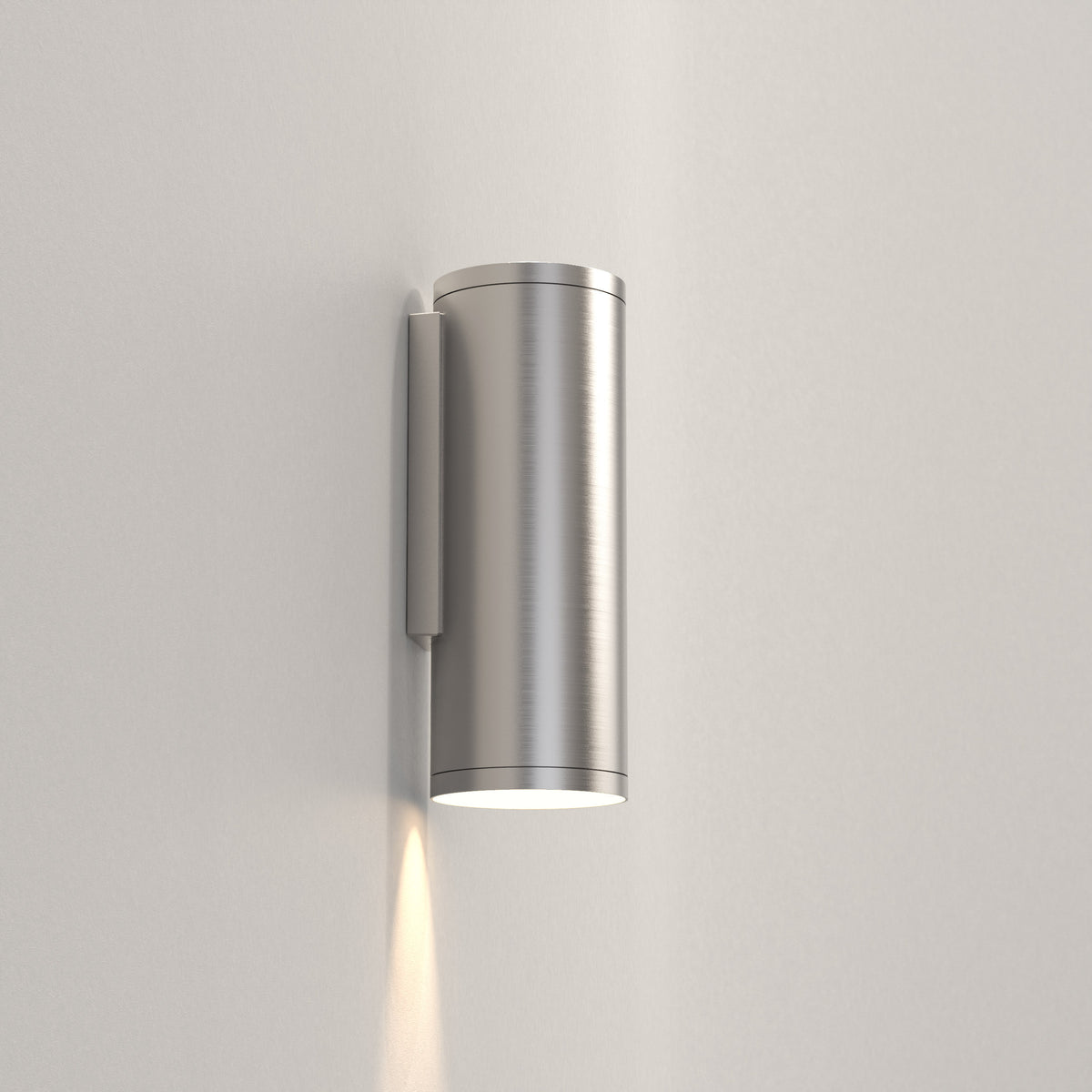 Astro Ava 200 Coastal Wall Light in Brushed Stainless Steel, illuminating a white wall