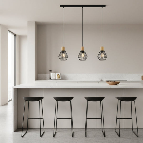 Three black geometric pendant lights with wooden tops hang above a kitchen island with four black bar stools